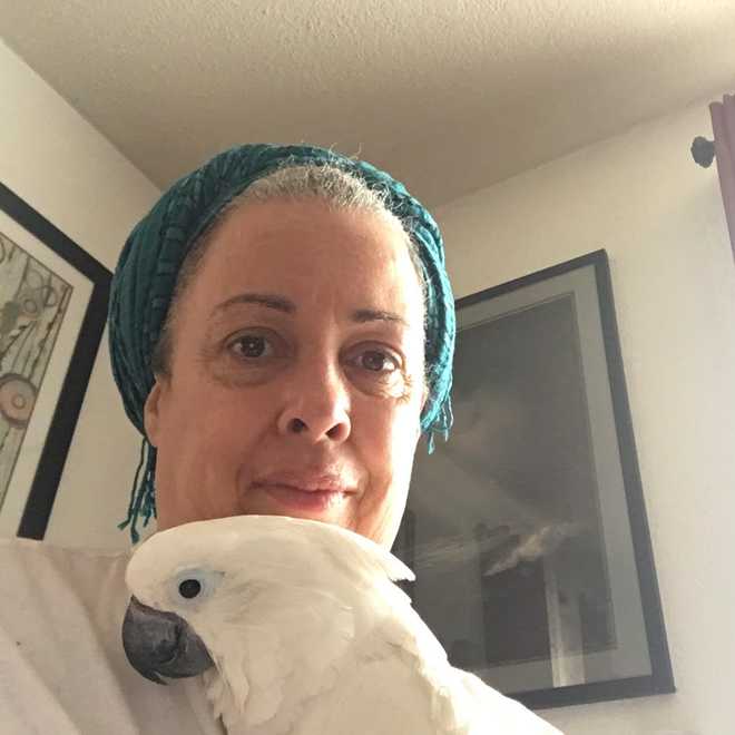 cousin Cabrini with her pet cockatoo