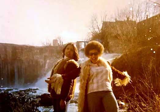 Cynthia and Cathy smith wearing their finest 70's furry fashion by a waterfall