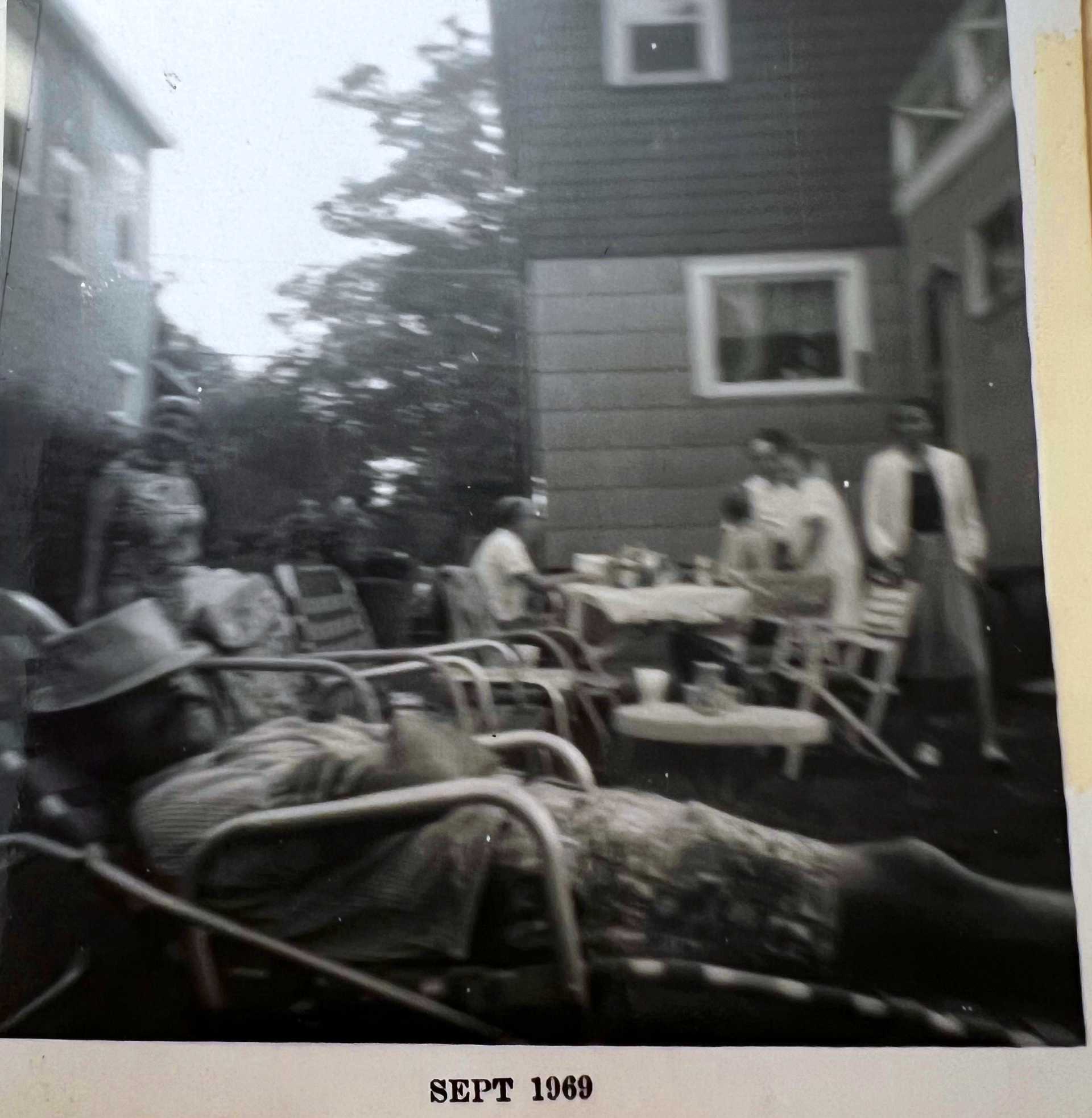 a photo of people picnicing in the yard of 125 first stree.